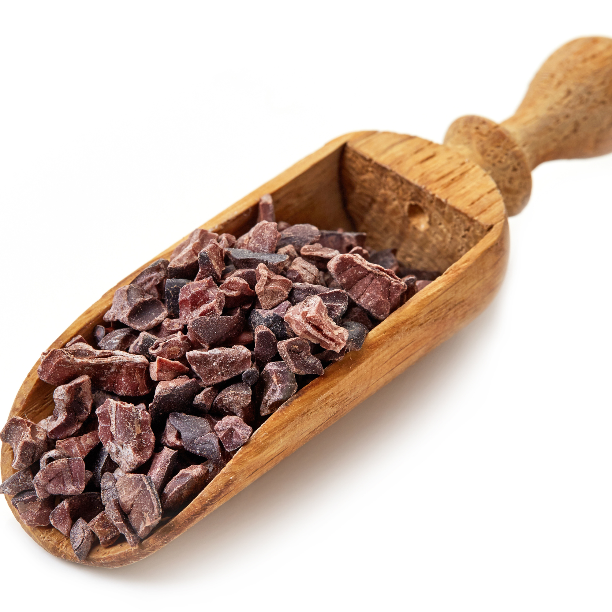 Wooden scoop filled with cacao nibs
