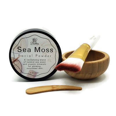 4 ounce jar of sea moss powder placed next to a bamboo facial bowl, a facial brush and a bamboo spatula
