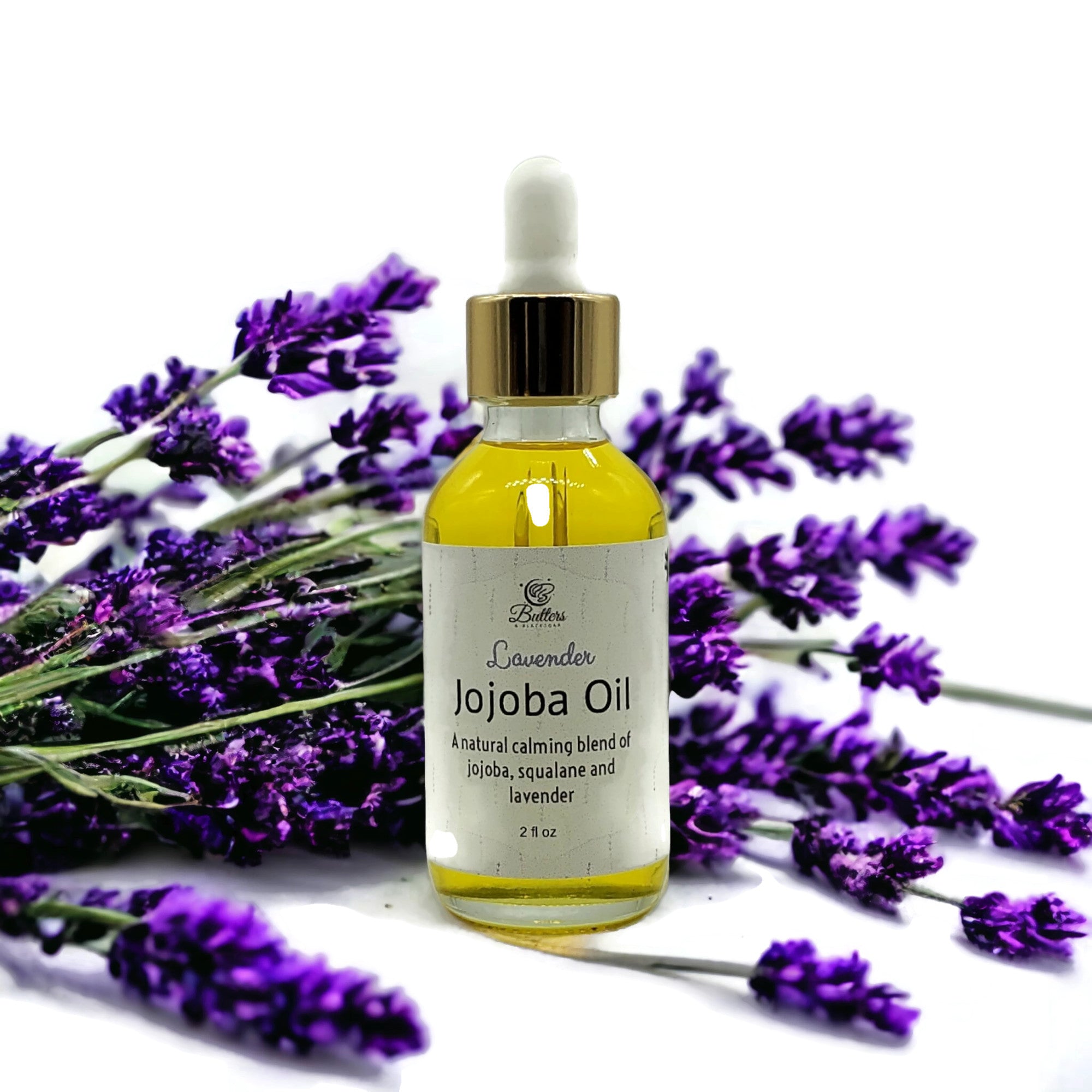 2 ounce dropper bottle of lavender jojoba oil surrounded by lavender flowers