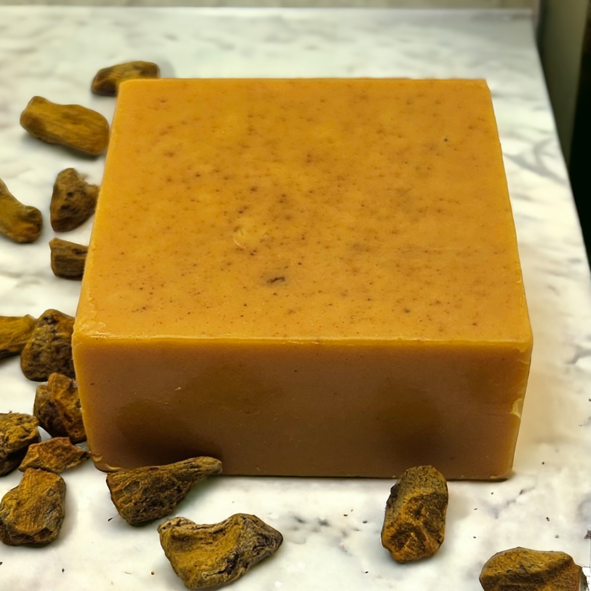 A square bar of turmeric and kojic acid soap