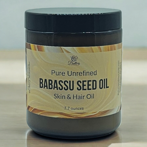 a jar of babassu oil sitting on a wooden countertop